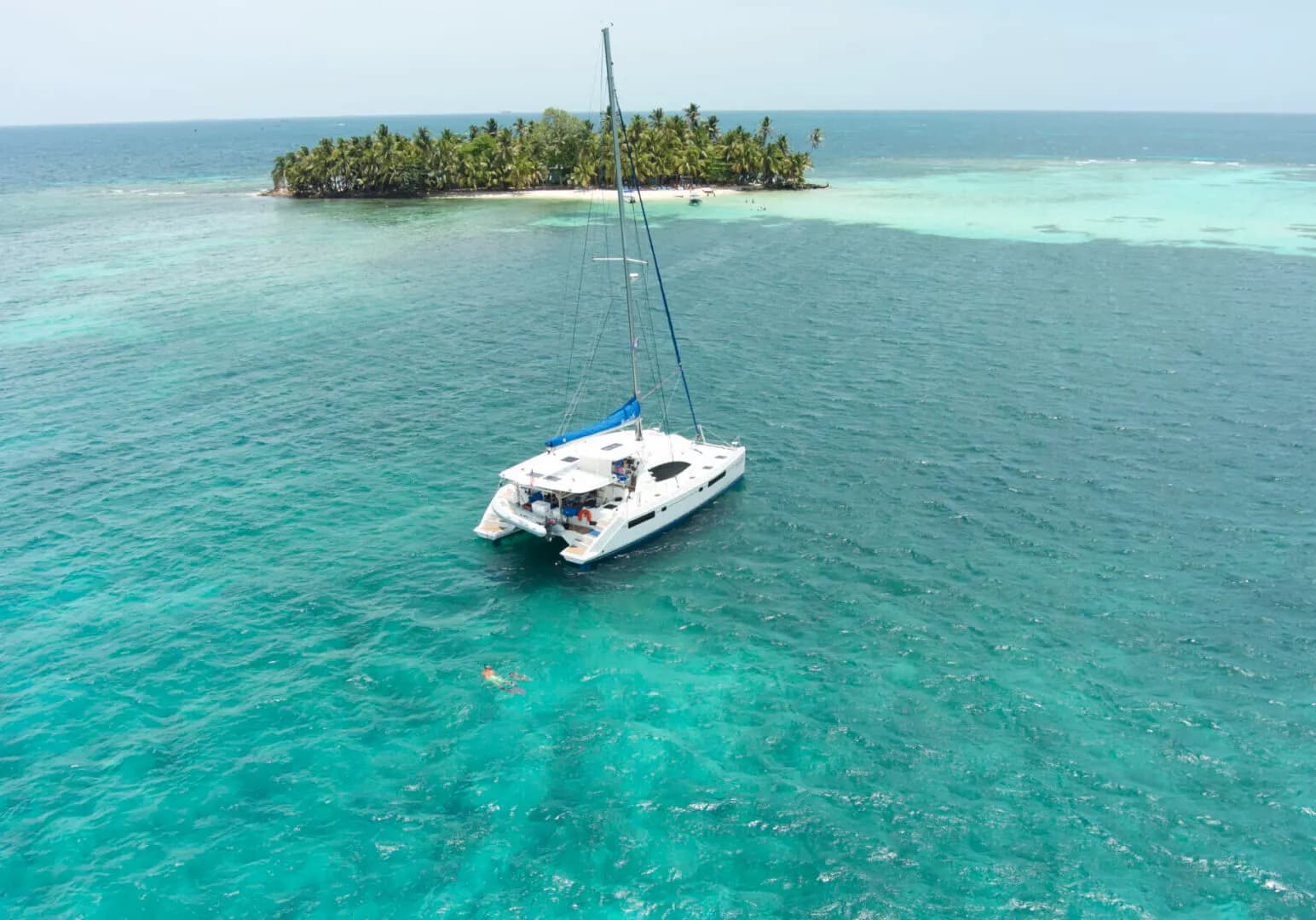 Catamaran anchored off a palm caye