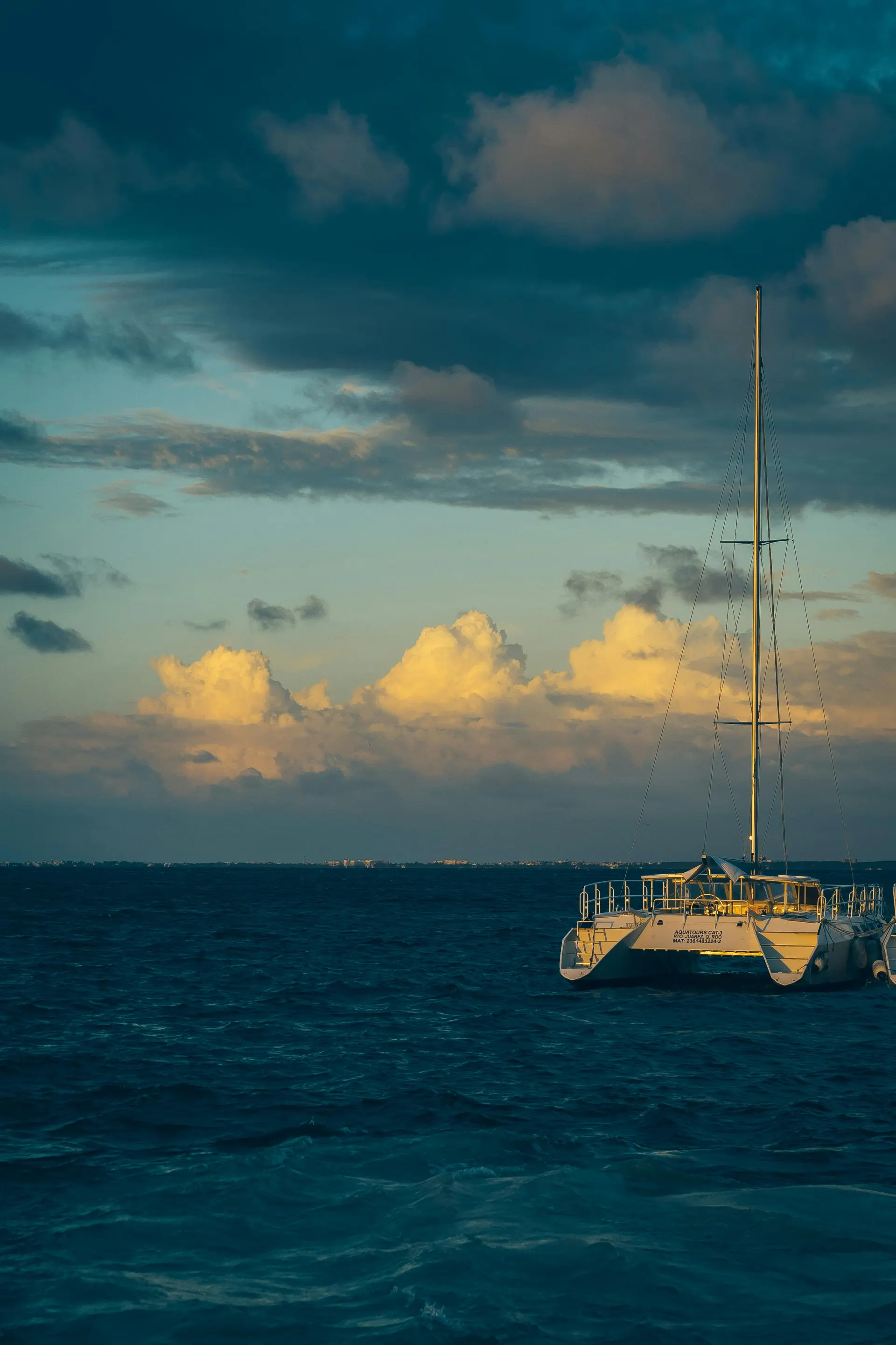 Catamaran at dusk off Isla Mujeres